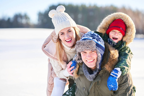 Nice happy family having fun on winter snow - Photo, Image