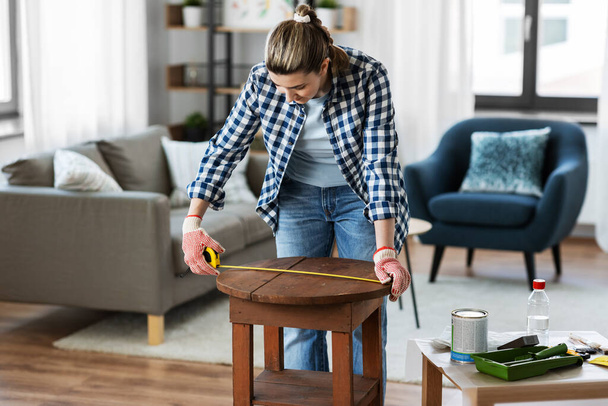 woman with ruler measuring table for renovation - Photo, Image