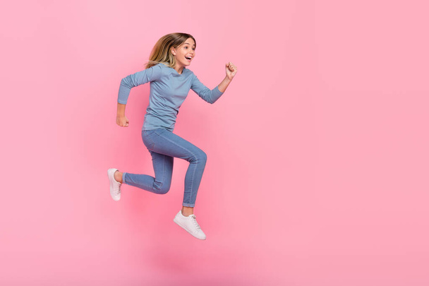 Full size profile side photo of young excited girl run energetic look empty space hurry isolated over pink color background - Foto, Imagem