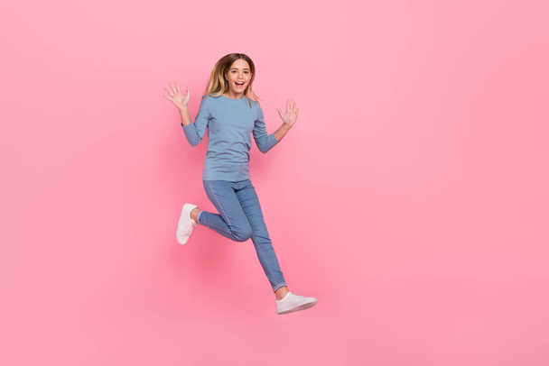 Full body photo of young pretty girl walk jump wave arms hello energetic isolated over pink color background - Photo, image