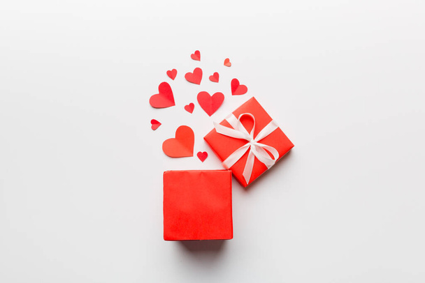 Happy valentines day opened heart shape gift box with small hearts, on colored background, valentines day card - top view concept. - Fotoğraf, Görsel