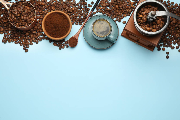 Flat lay composition with ground coffee and roasted beans on light blue background, space for text - Zdjęcie, obraz