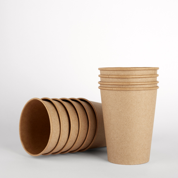 Empty disposable kraft paper cups. White background. Free space for your brand - Фото, зображення