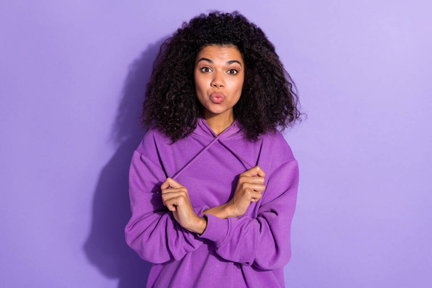 Photo of positive adorable girl kiss lips arms hold pull laces look camera isolated on purple color background - Φωτογραφία, εικόνα