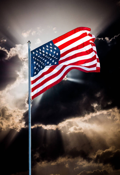  American flag against the backdrop of the evening sky and the setting sun - Photo, Image