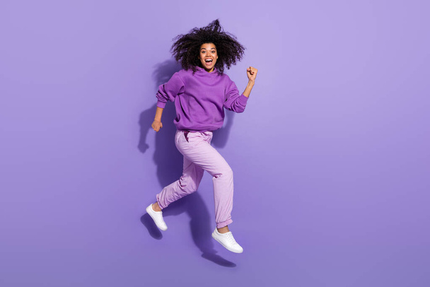 Full body profile portrait of afro hairstyle excited crazy lady hurry fast isolated on violet color background - Photo, image