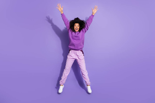Full size portrait of pretty cheerful lady overjoyed raise hands good mood isolate don violet color background - Fotó, kép