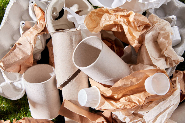 close up of crumpled paper waste on grass - Valokuva, kuva