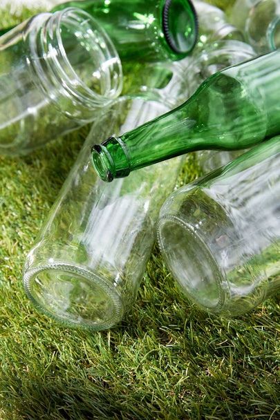 close up of empty glass bottles and jars on grass - Valokuva, kuva