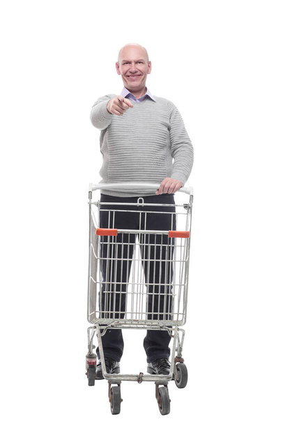 in full growth. a happy man with a shopping cart. - Fotó, kép