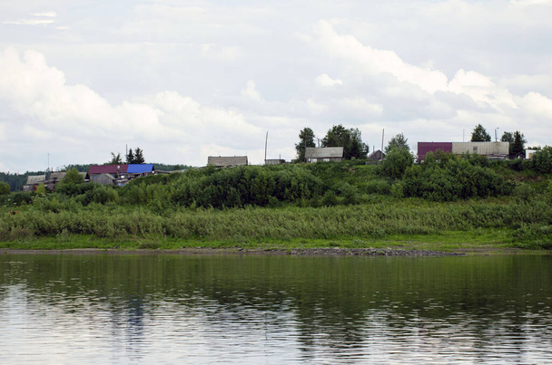  30.07.2021  Russia. Krasnoyarsk region. View of the village of Verkhneimbatsk from the Yenisei River. - Zdjęcie, obraz