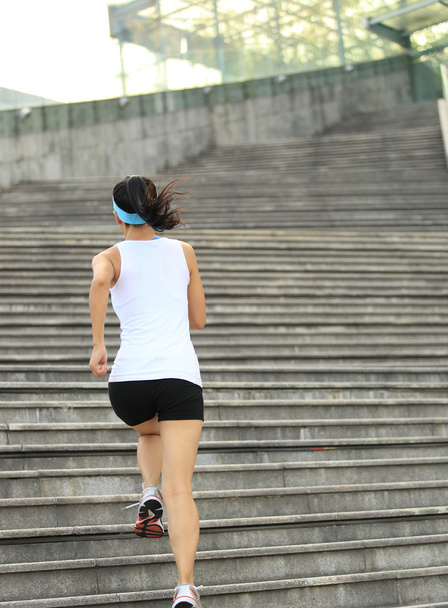 Runner athlete running on stairs. - Zdjęcie, obraz
