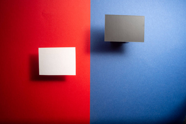 black and white mock up business cards on a blue and red background . - Photo, Image