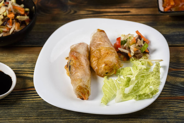 homemade spring rolls with vegetables and chicken served in various sauces - Foto, Imagem