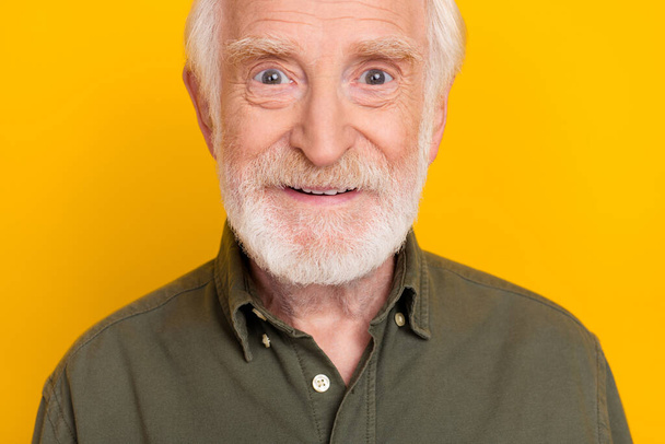 Cropped close up photo of satisfied glad aged man toothy smile look camera isolated on yellow color background - 写真・画像