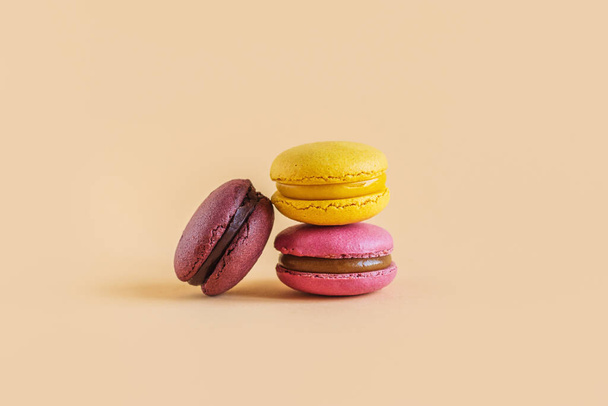 Tasty french macarons on a yellow pastel background. Place for text. - 写真・画像