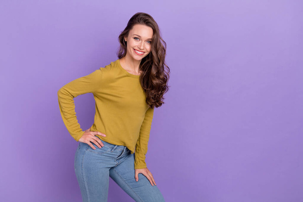 Photo of satisfied glad girl put hand on waist beaming smile look camera isolated on violet color background - Zdjęcie, obraz