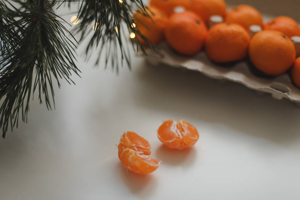 Christmas background with fir tree branches and tangerines. Merry Christmas and Happy New Year Greeting Card - 写真・画像