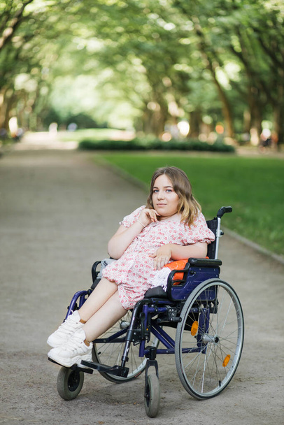 Woman with spinal muscular atrophy smiling at park - Φωτογραφία, εικόνα