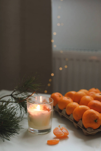 Christmas background with fir tree branches and tangerines. Merry Christmas and Happy New Year Greeting Card - 写真・画像