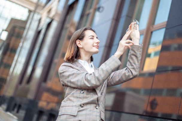Business business woman looking up through the lens of glasses in the city - 写真・画像