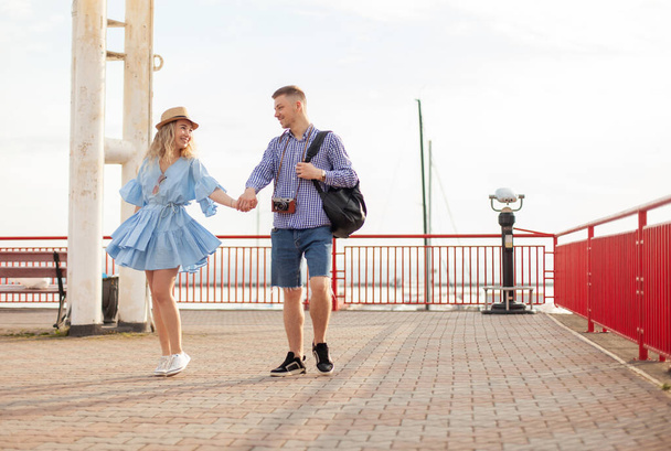 Enjoying every moment together. Young couple in love tourist Spend time walking together in the seaport. Romantic, love, travel concept - Photo, Image