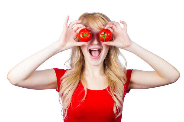 Woman holding, showing tomatoes over her eyes - Фото, зображення