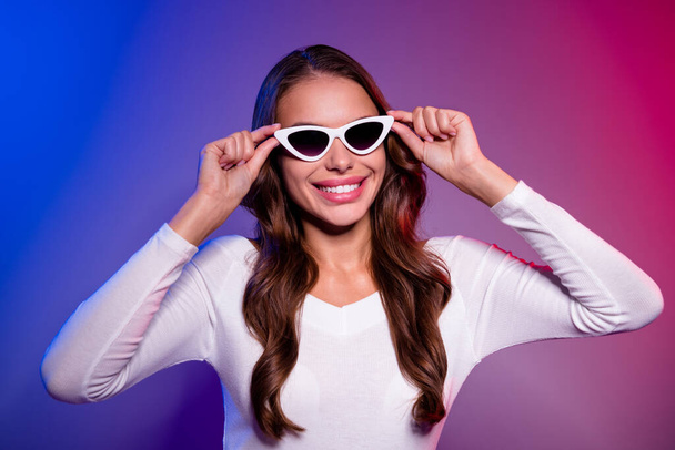Photo of pretty shiny young lady dressed off-shoulders shirt arms dark eyewear smiling isolated filter red blue color background - Photo, Image