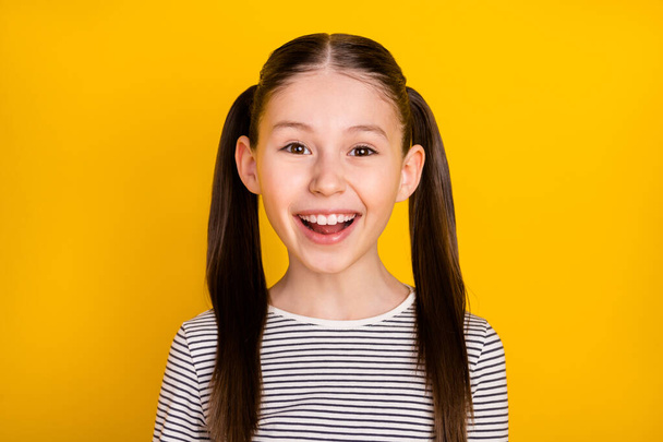 Photo of young attractive school girl happy positive toothy smile isolated over yellow color background - Foto, afbeelding