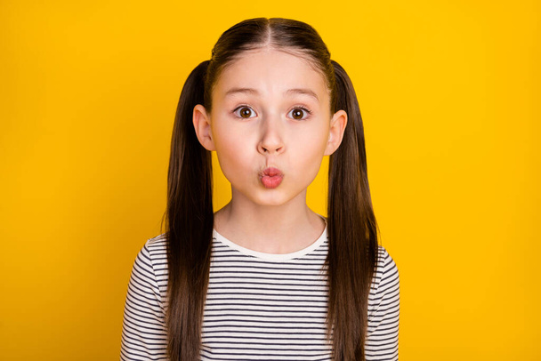 Photo of young attractive school girl pouted lips send air kiss isolated over yellow color background - Foto, afbeelding