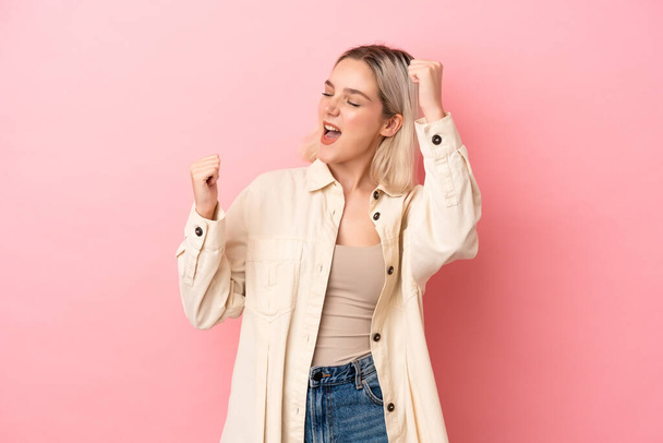 Young caucasian woman isolated on pink background celebrating a victory - Photo, Image