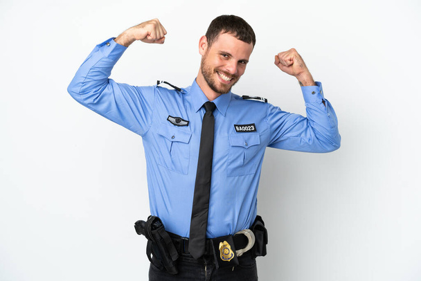 Young police Brazilian man isolated  on white background doing strong gesture - Photo, Image