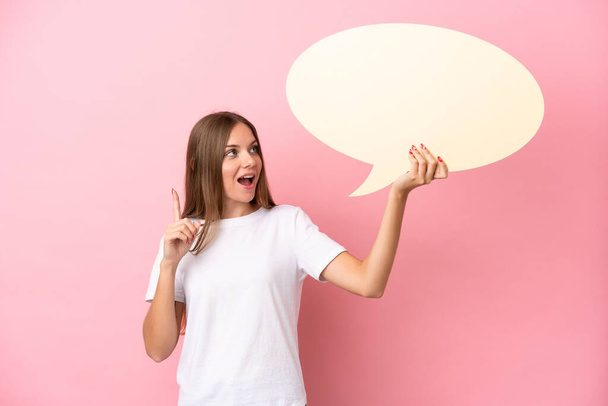 Young Lithuanian woman isolated on pink background holding an empty speech bubble and thinking - Photo, Image