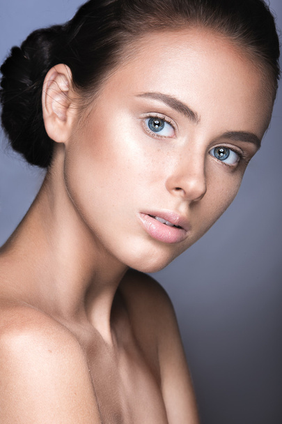 Beautiful young girl with a light natural make-up. Beauty face - Valokuva, kuva