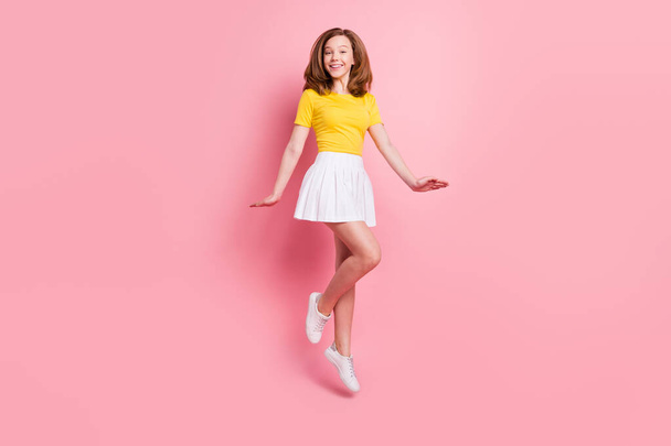 Full length photo of young school girl happy positive smile have fun jump up isolated over pink color background - Photo, image
