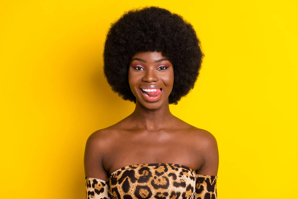 Photo of cute flirty dark skin woman dressed leopard outfit licking lips smiling isolated yellow color background - Fotoğraf, Görsel