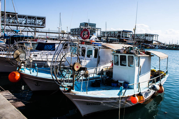 Limassol, Cyprus - December 17, 2021 Fishing boat moored at Limassol Marina during the winter period and the coronavirus epidemic hitting Cyprus, fishing activity is greatly reduced at this time - Fotó, kép