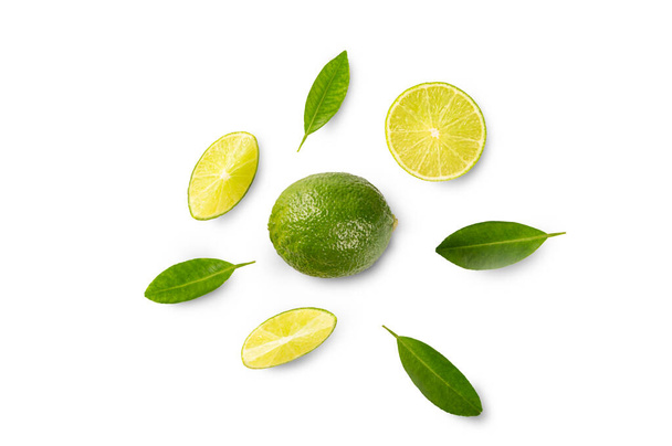 Top view of Fresh lime citrus fruit with slice piece and green leave on white background.  - Foto, immagini