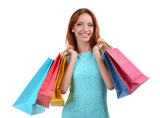Beautiful young woman with shopping bags isolated on white - Fotó, kép