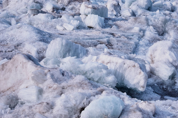 Melting river ice. Columnar and needle-like structure of crystals. Ice floe in the spring on the banks of the Amur River. Close view. Large blocks of solid water. Selective focus. - 写真・画像