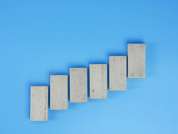 business up chart concept, wooden block isolated on blue background - Foto, Bild