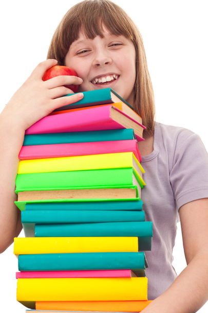 Girl with book stack and apple - Фото, изображение