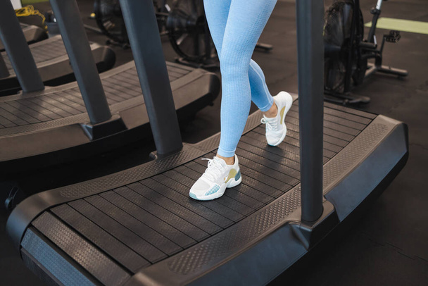 Woman legs on mechanical treadmill - Photo, Image