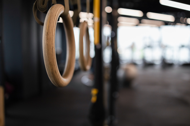 Close up gymnastic rings hang in gym.  - Photo, Image