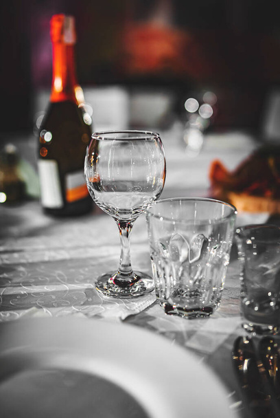 table in a restaurant with white tablecloth and empty glasses - Fotoğraf, Görsel