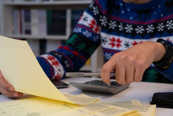 Young businessman working in office worker in christmas sweater - Photo, Image