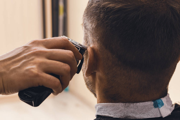 Cortadora de cabello y cabeza de hombre, peluquería en casa. - Foto, Imagen