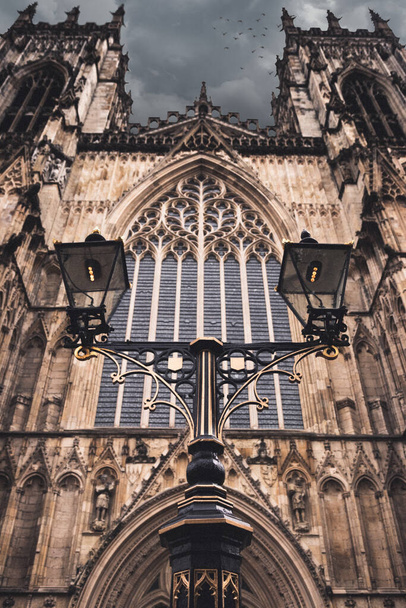 A vertical shot of the external view of the York Minster cathedral against a cloudy sky in UK - Zdjęcie, obraz