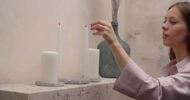 Woman in pajamas lights the candles with match in slow motion at her bedroom, 4k Prores HQ - Video, Çekim