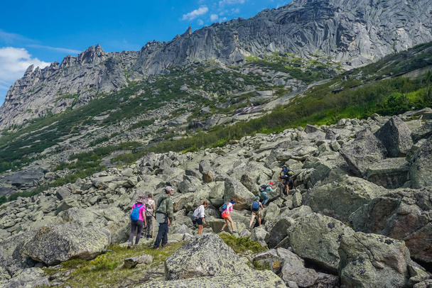 Ergaki, Krasnoyarsk Territory, Russia - July 21, 2020: Hikers in the Sayan Mountains - Фото, изображение